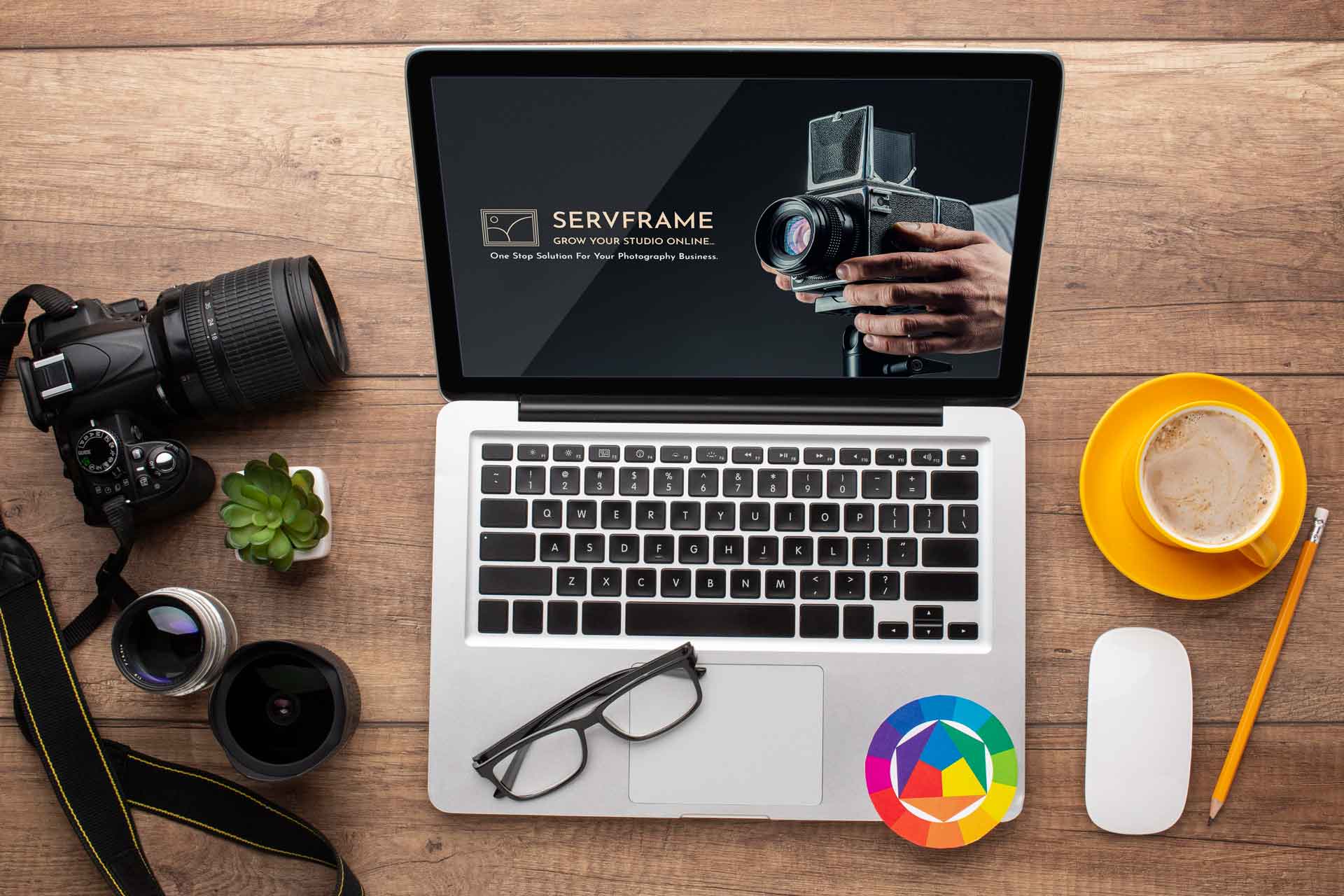 A laptop screen displaying Servframe's logo and a camera with a cup of coffee on the desk.