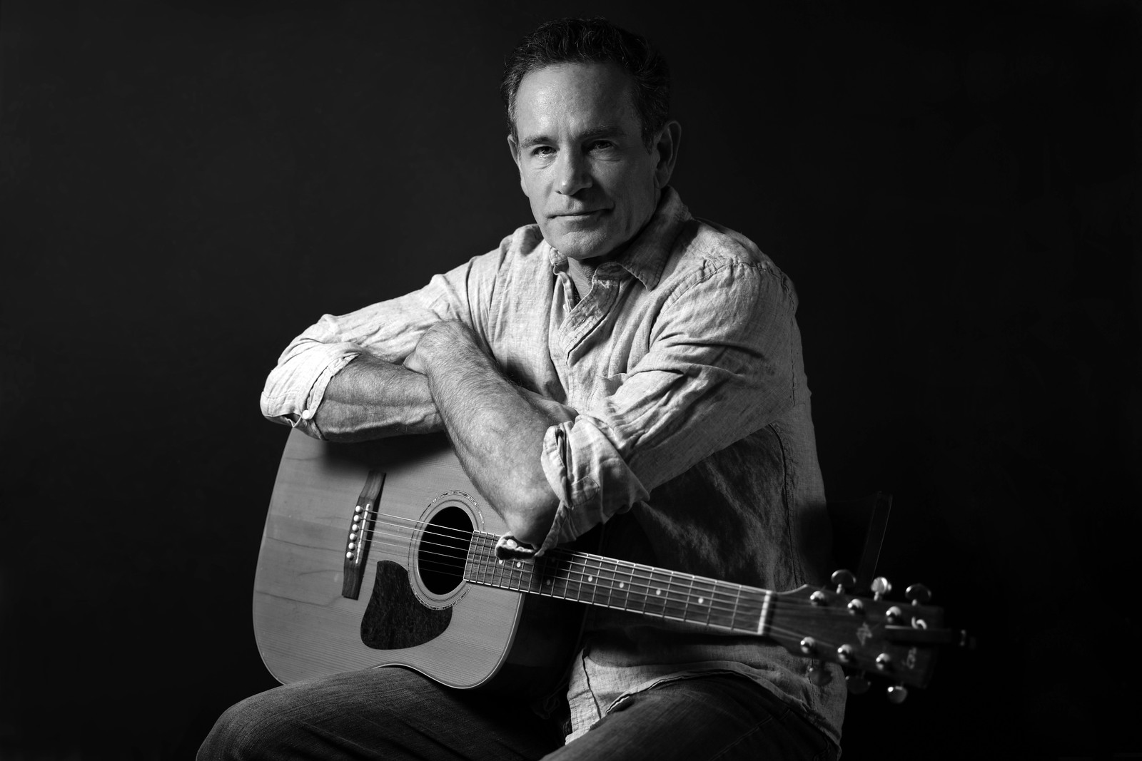 black and white men with guitar headshot